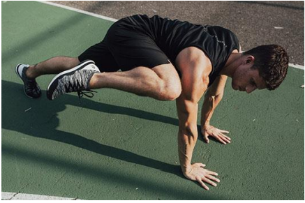 Man completing mountain climbers on the floor with his knee up 