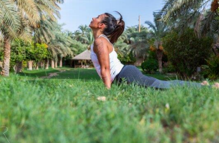 woman streching doing yoga on the grass